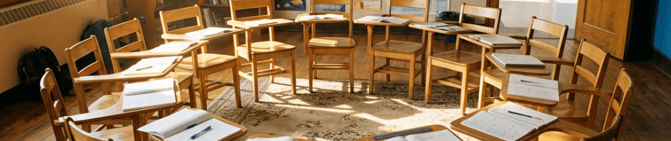 Sunlit classroom with chairs, open notebooks, and a whiteboard